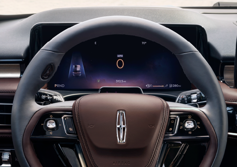 The steering wheel of 2025 Lincoln Aviator® SUV is shown with black and brown accents. | Gates Lincoln in Richmond KY