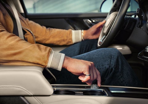 The driver of a 2024 Lincoln Corsair® SUV is shown selecting the drive mode. | Gates Lincoln in Richmond KY