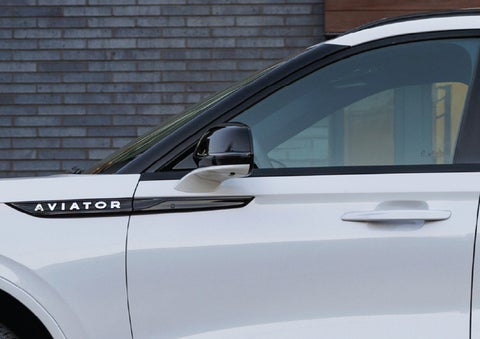 The driver’s side door and fender badging of a white 2026 Lincoln Aviator® SUV are showcased. | Gates Lincoln in Richmond KY