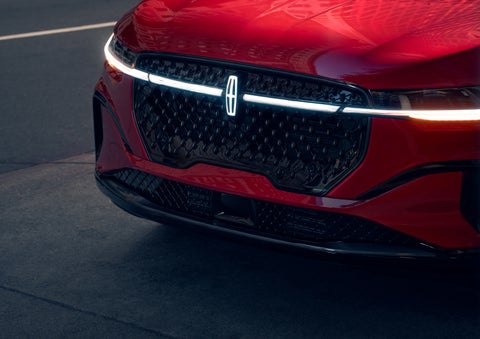 The available front LED light bar and center Lincoln Star logo glow at dusk. | Gates Lincoln in Richmond KY