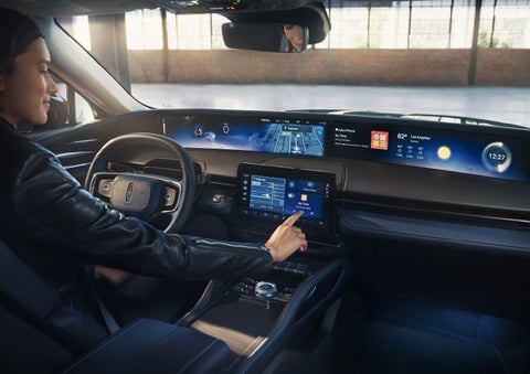 The driver of a 2026 Lincoln Nautilus® SUV interacts with the center touchscreen. | Gates Lincoln in Richmond KY